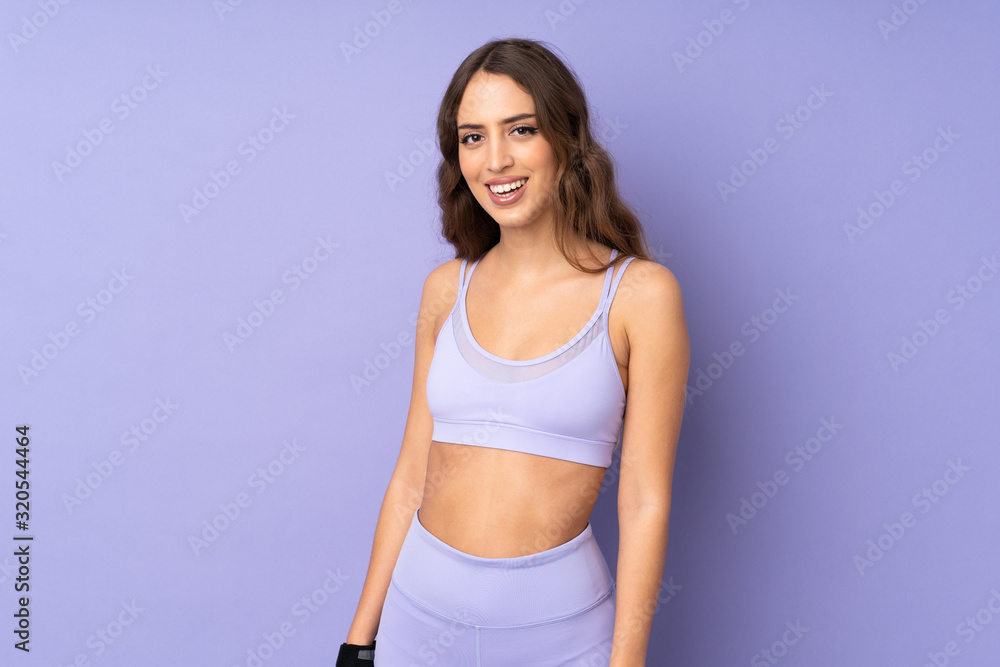 Young sport woman over isolated purple background happy and smiling Young sport woman over isolated purple background happy and smiling