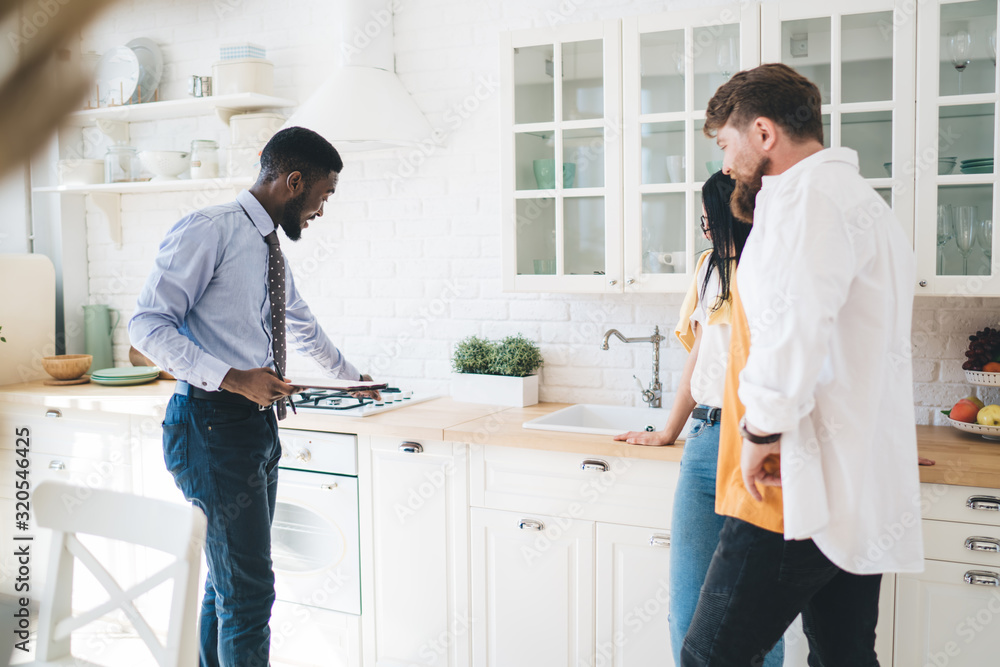© BullRun - Black agent showing new apartment to couple