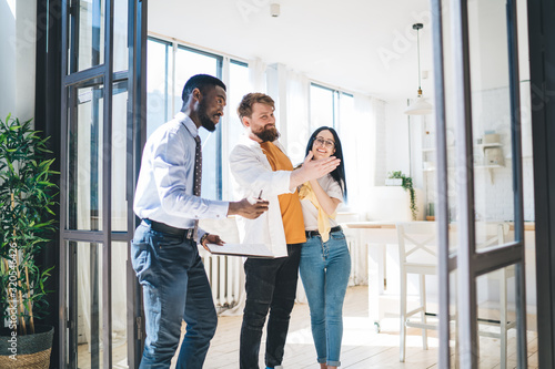 Fotografija Young couple looking new home with agent