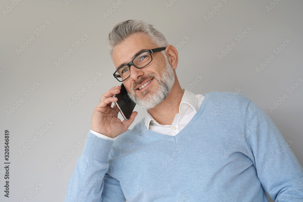 Portrait of middle-aged man using smartphone, isolated Portrait of middle-aged man using smartphone, isolated