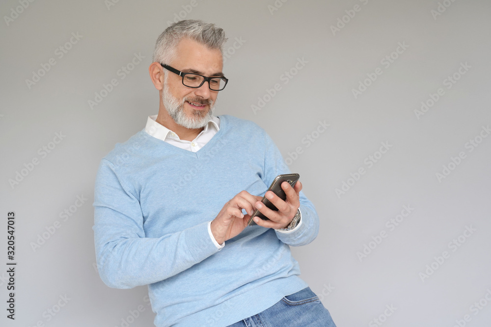 Portrait of middle-aged man using smartphone, isolated Portrait of middle-aged man using smartphone, isolated