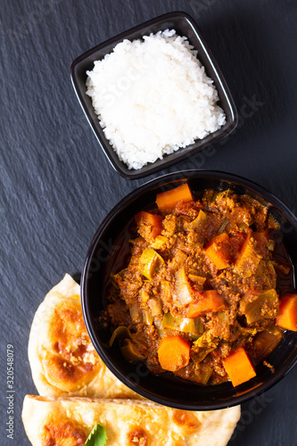 Oriental food concept spicy grounded or minced beefs masala curry with naan bread and rice