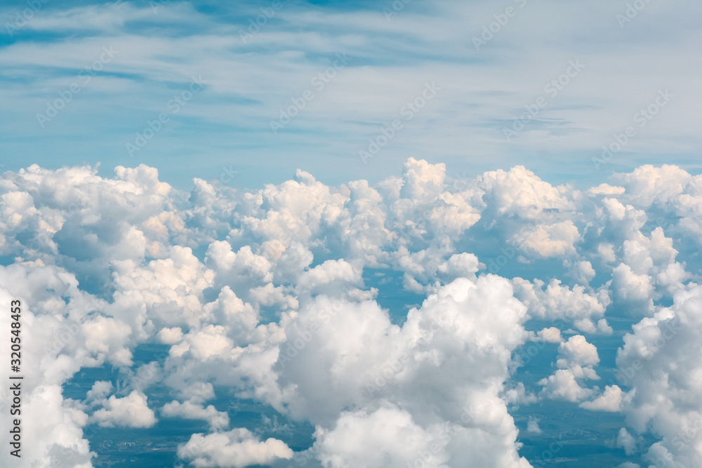Blue sky with fluffy clouds. Aerial view from airplane window Blue sky with fluffy clouds. Aerial view from airplane window