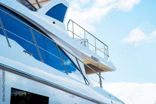 Nautical background of luxury yachts, with black tinted windows and chrome metal railings on white fiber glass bows