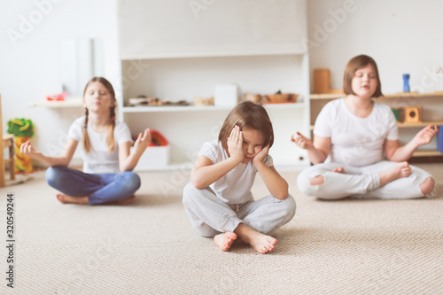 Children yoga, offended child in lotus position