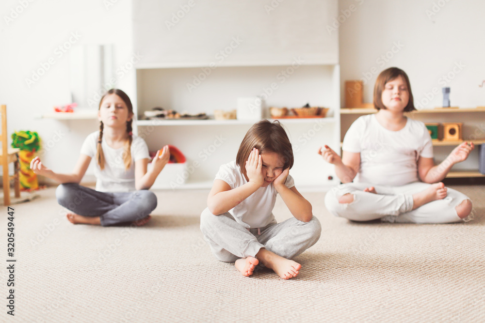 Children yoga, offended child in lotus position Children yoga, offended child in lotus position