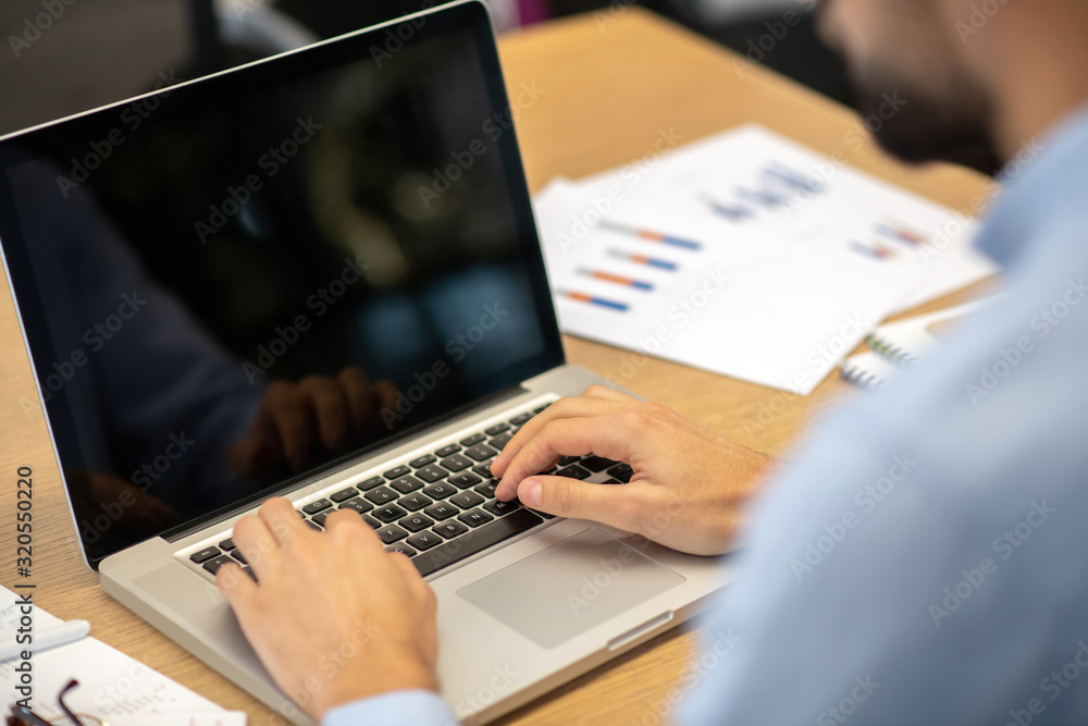 Close up picture of mans typing hands on a laptop Close up picture of mans typing hands on a laptop