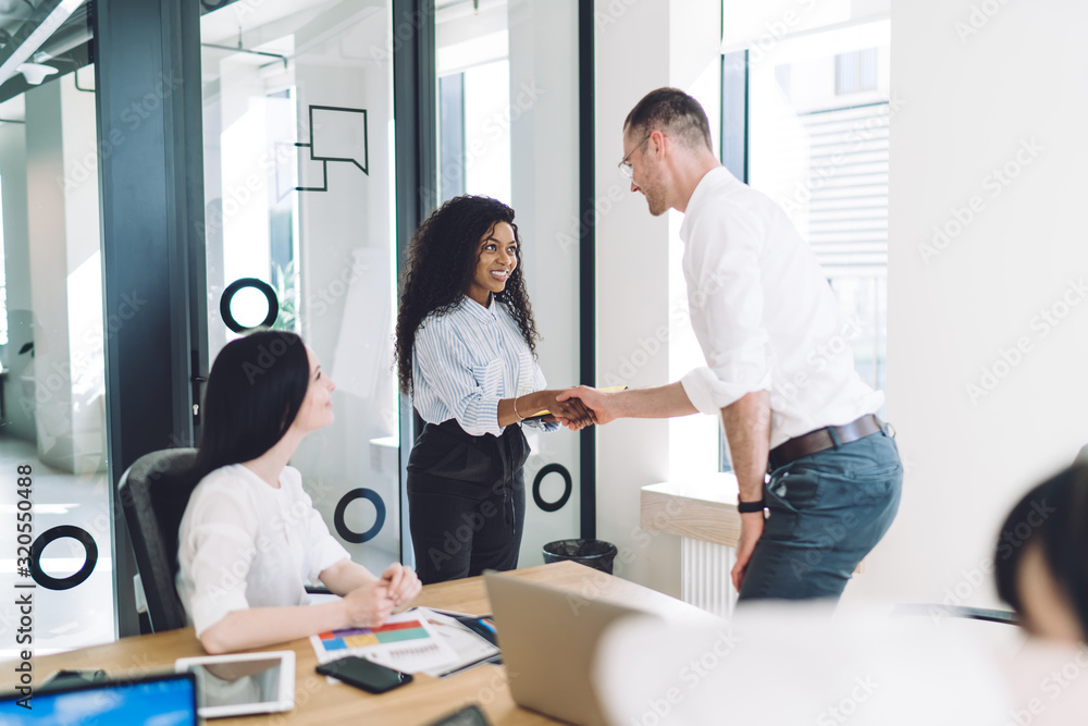 Business partners shaking hands at meeting Business partners shaking hands at meeting