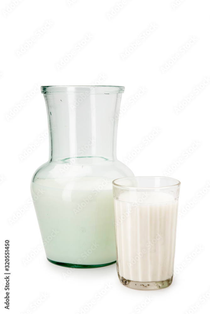 Milk in a glass decanter, glass on a white background Milk in a glass decanter, glass on a white background