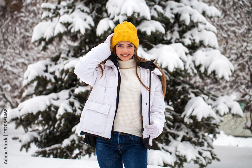 Portrait of a young happy woman on a background of a winter park Portrait of a young happy woman on a background of a winter park