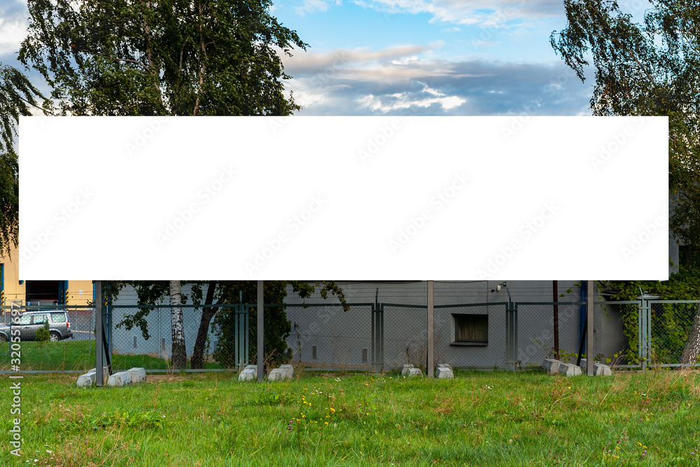 Blank advertising billboard mockup in front of industrial building Blank advertising billboard mockup in front of industrial building