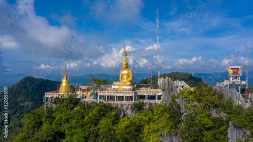 Aerial view Tiger Cave Temple  Buddha on the top Mountain with blue sky of Wat Tham Seua  Krabi Thailand