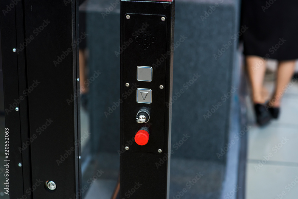 Elevator buttons on the background of blurry female legs Elevator buttons on the background of blurry female legs