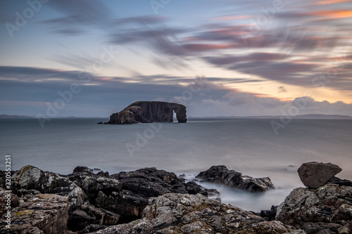 A long exposure of 'Dore Holm' (drinking horse island), near Stenness Beach in Shetland photo