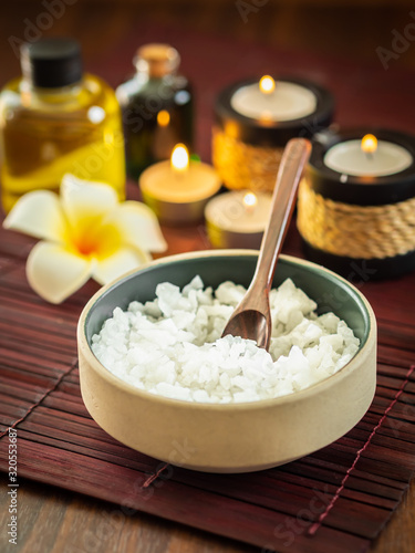 Spa pure mineral sea salts with bottles of massage oil and aromatheray candles (Thai style)