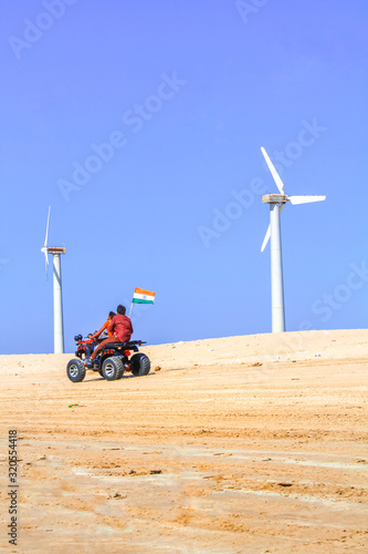 bottom view of modern red all-terrain vehicle standing in beach on cloudy day,Motor cross sports on ocean sand dune. Kids summer vacation activity. beach bike at mandvi Gujarat india