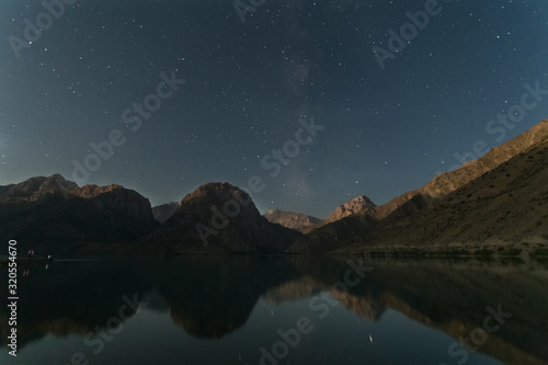 astrophotography of a night starry sky with a milky way over a lake