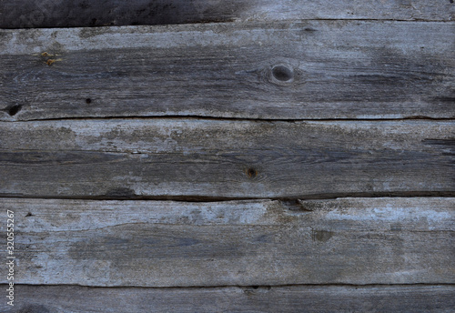  texture of gray wooden boards folded horizontally into a palisade