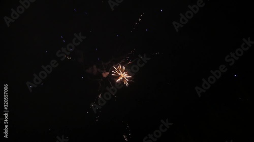 shining fireworks with lights in night sky. glowing fireworks show. New year's eve fireworks celebration. multico lored fireworks in night sky. photo