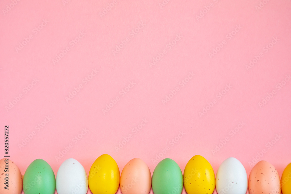 Fototapeta premium Colorful easter eggs on pink background