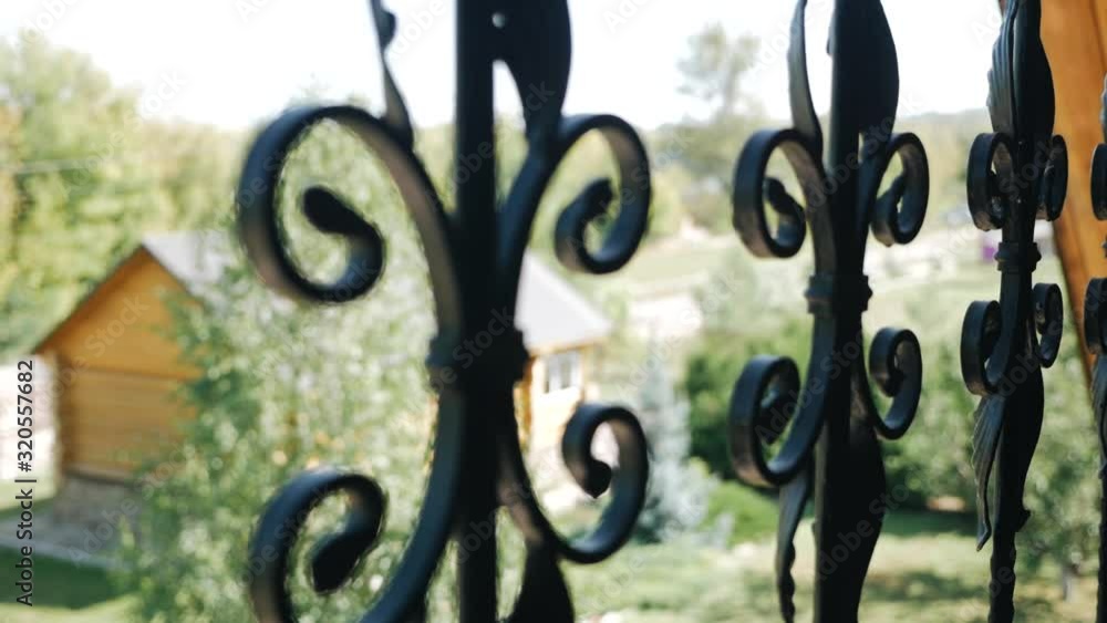 Shot of of a beautiful decorative cast iron wrought fence with artistic forging. Metal guardrail silhouette Shot of of a beautiful decorative cast iron wrought fence with artistic forging. Metal guardrail silhouette