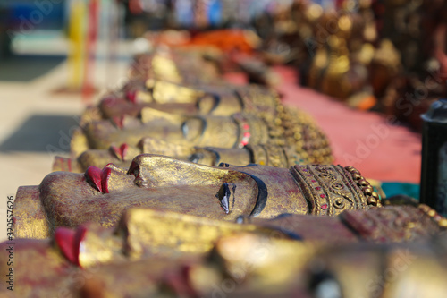 Fototapeta Naklejka Na Ścianę i Meble -  A lot of bright souvenirs on the counter of the ancient souvenir market in Myanmar