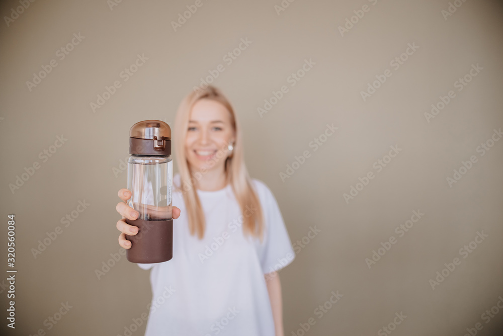 smiling Woman holding reusable water sport bottle .Horizontal view copyspace Eco friendly and Zero waste smiling Woman holding reusable water sport bottle .Horizontal view copyspace Eco friendly and Zero waste