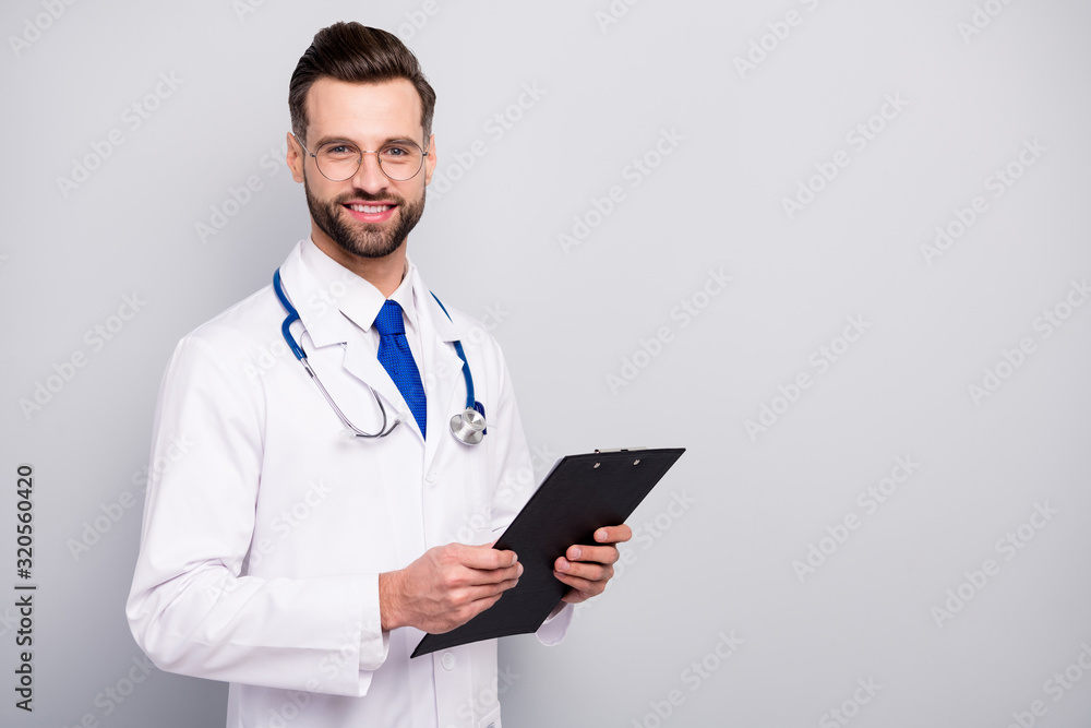 Portrait of his he nice attractive smart clever intellectual cheerful cheery bearded guy doc holding in hands clipboard paper document visit isolated on light white gray pastel color background Portrait of his he nice attractive smart clever intellectual cheerful cheery bearded guy doc holding in hands clipboard paper document visit isolated on light white gray pastel color background