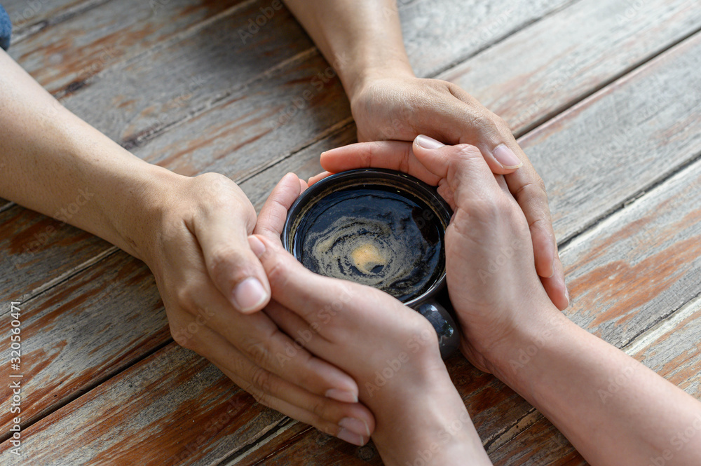 hands lovers holding a hot cup of coffee, selective focus Valentine's Day. love. Selective focus. hands lovers holding a hot cup of coffee, selective focus Valentine's Day. love. Selective focus.