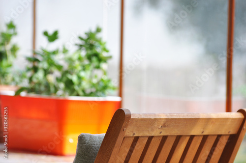 Comfortable summer balcony with many potted plants, plants and table © Tayfun
