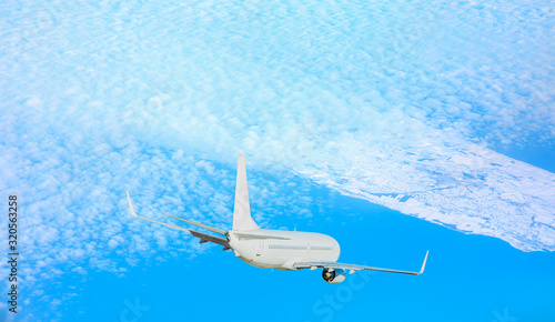 White passenger airplane in the clouds - Passenger plane trying to land on an icy runway