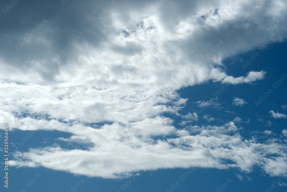 Fototapeta premium Blue sky with picturesque, white and gray clouds