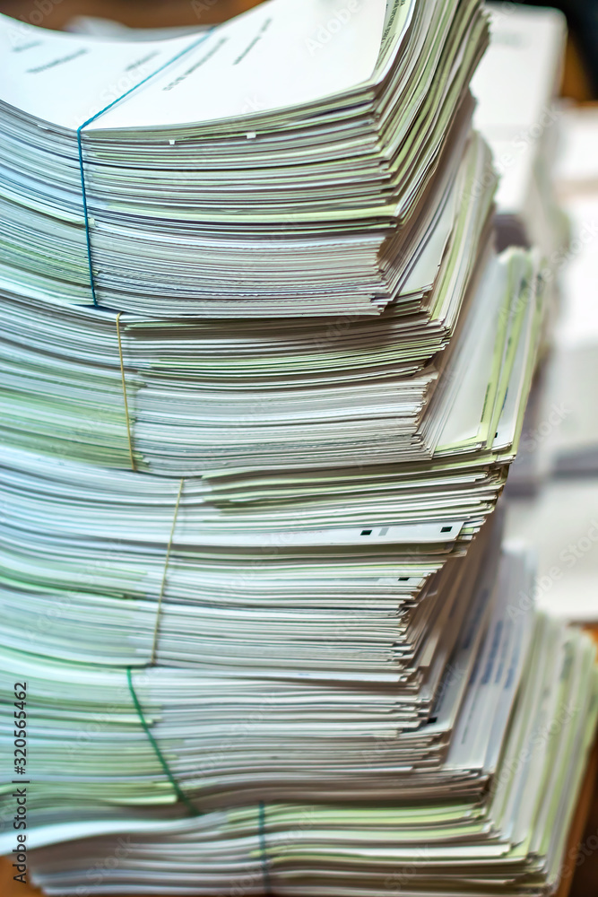 bundles bales of paper documents. stacks packs pile on the desk in the office bundles bales of paper documents. stacks packs pile on the desk in the office