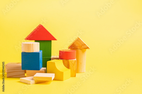 Photography Children's wooden toys on a yellow background concept zero west