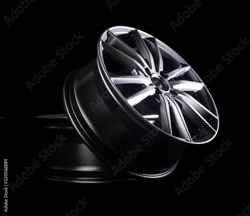 Cuadro en lienzo Modern automotive alloy wheel made of aluminum on a black background, industry