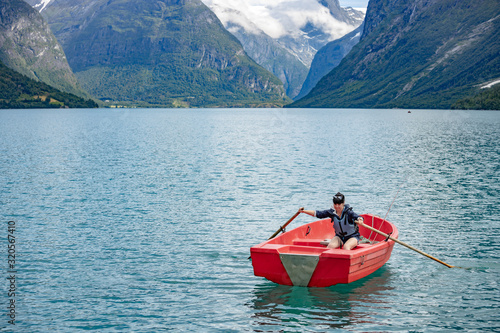 Woman fishing on a boat.