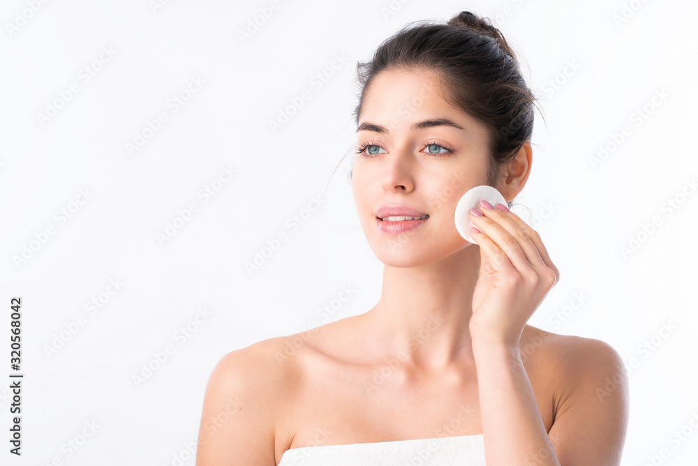 Young woman cleansing her face Young woman cleansing her face