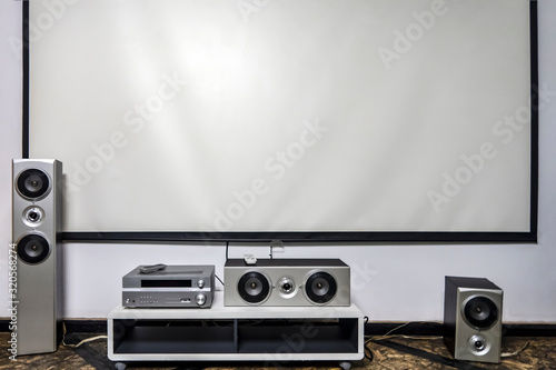 Home cinema. Large white screen home theater system with stereo
