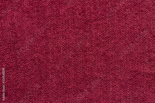 Dark red knitted wool fabric texture background