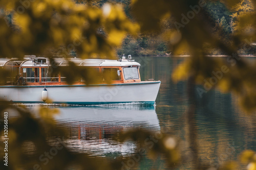 Boat on the lake in autumn with leaves