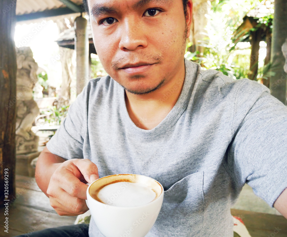 Asia man selfie and drinking hot coffee in the morning. Asia man selfie and drinking hot coffee in the morning.