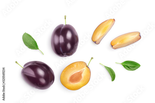 Obraz na płótnie fresh purple plum and half with leaves isolated on white background with clipping path and full depth of field