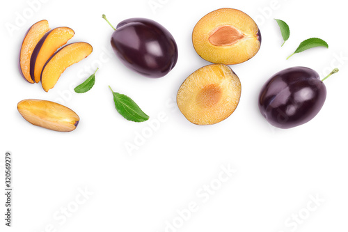 Fotografiet fresh purple plum and half with leaves isolated on white background with clipping path and copy spase for your text