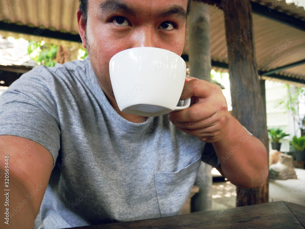 Asia man selfie and drinking hot coffee in the morning. Asia man selfie and drinking hot coffee in the morning.