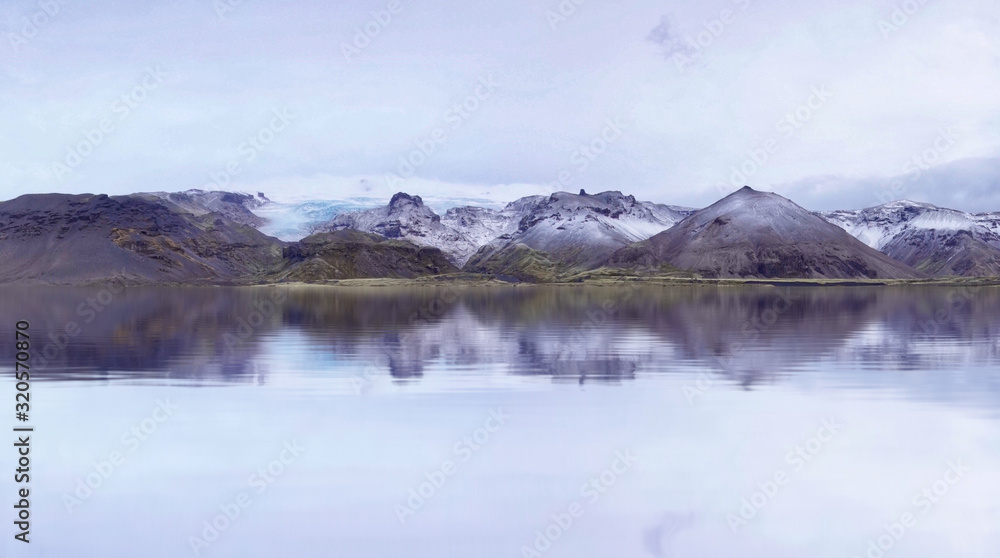 Beautiful scenery Eyjafjallajokull, Iceland with smooth reflection and glacier on the linear of mountains.