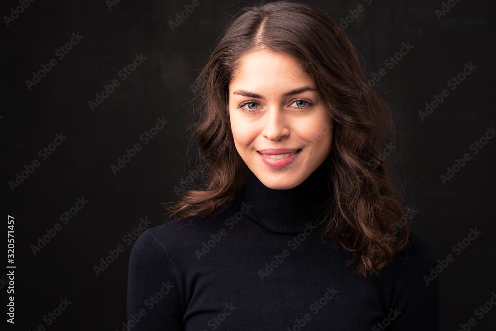 Beautiful young woman portrait at isolated black background Beautiful young woman portrait at isolated black background