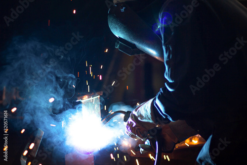 Metal workers use manual labor, Skilled welder, Factory workers making OT. Welder is welding the steel in the factory. welder Industrial automotive part in factory.