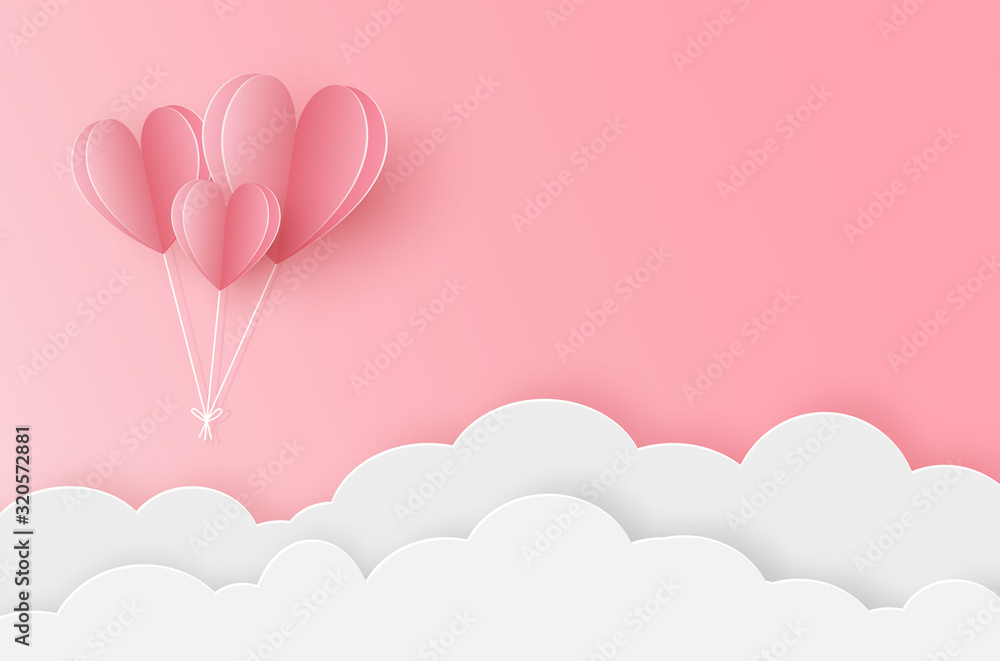 Paper heart balloons flying on the pink sky