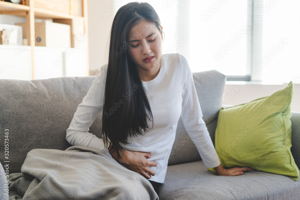 woman have a stomach pain from menstruation at home. woman have a stomach pain from menstruation at home.