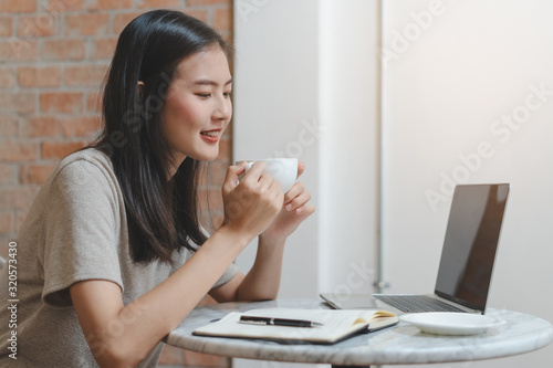 asian young woman sitting in the cafe and relax with her drink.